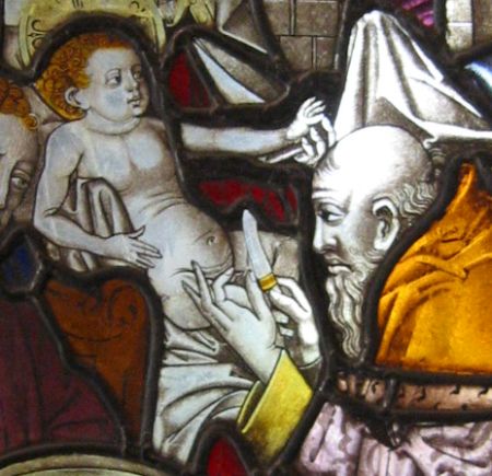 A stained glass window depicting the birth of a child.