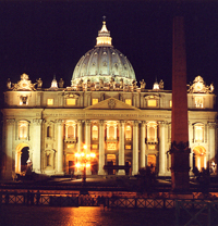St peter's basilica is lit up at night.