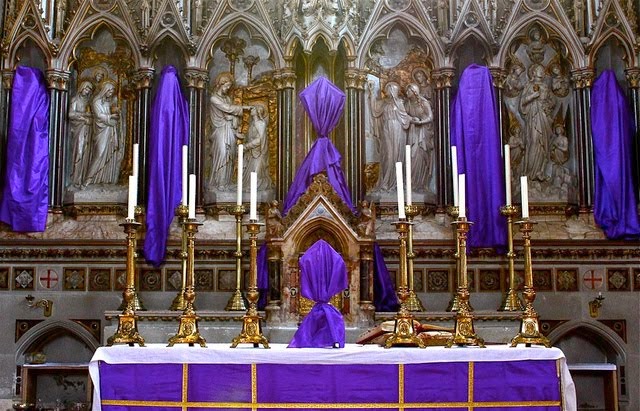 A purple altar in a church with ornate decorations.