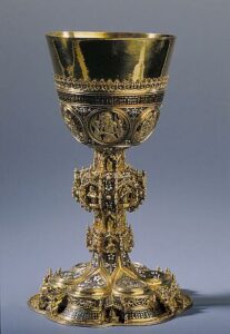 An ornate gold chalice on a blue background.
