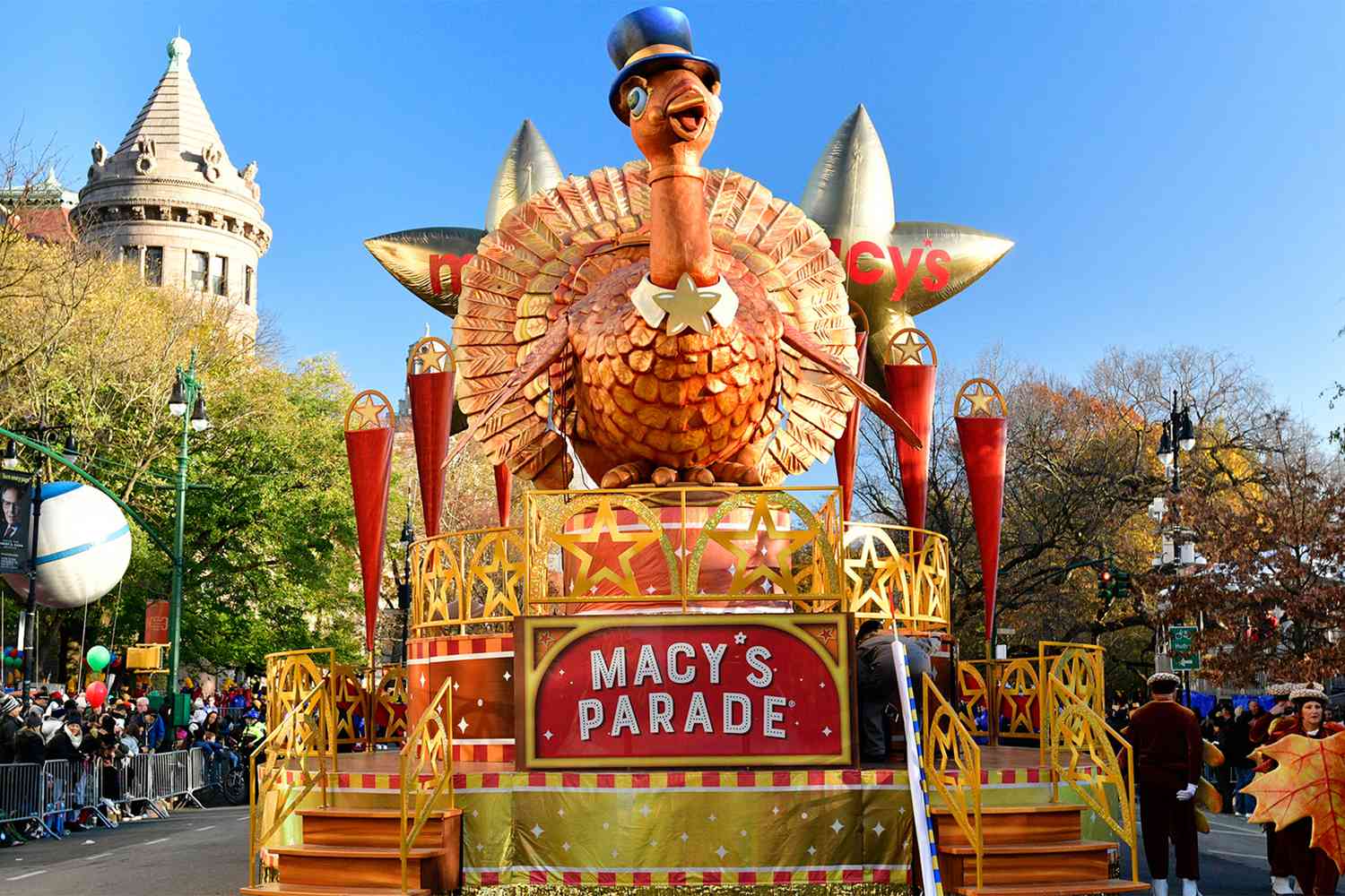 A float with a turkey on it in a parade.