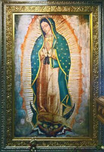 A picture of our lady Guadalupe in a photoframe