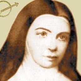 An image of a woman with long hair and a cross.